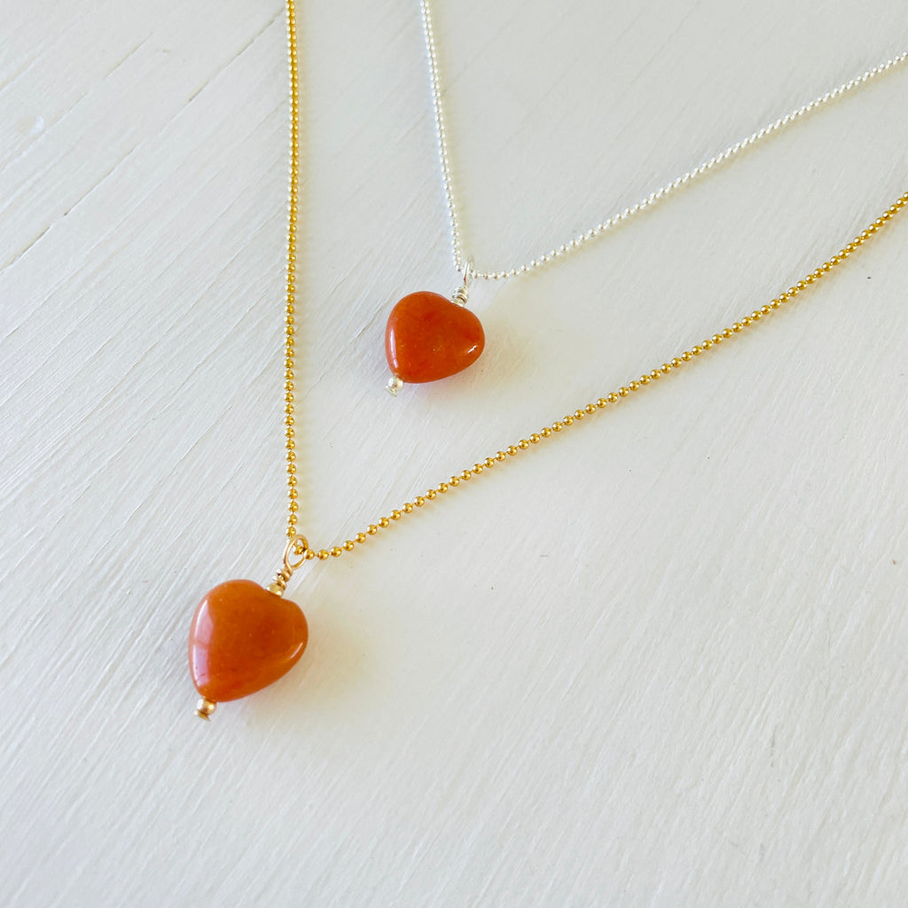 Orange Aventurine gemstone charm necklace on ball chain on a white background