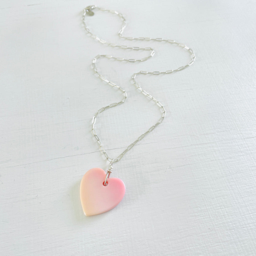ZEN by Karen Moore heart shape Conch Shell Necklace two necklaces, one 14kt gold-filled, one sterling silver on paperclip chains on a white background