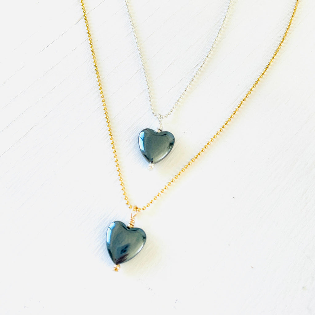 Hematite gemstone charm necklace on ball chain on a white background