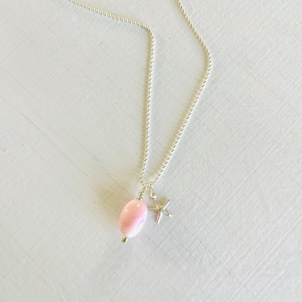 Star of the Ocean Conch Shell Charm Necklace by ZEN by Karen Moore on white wood