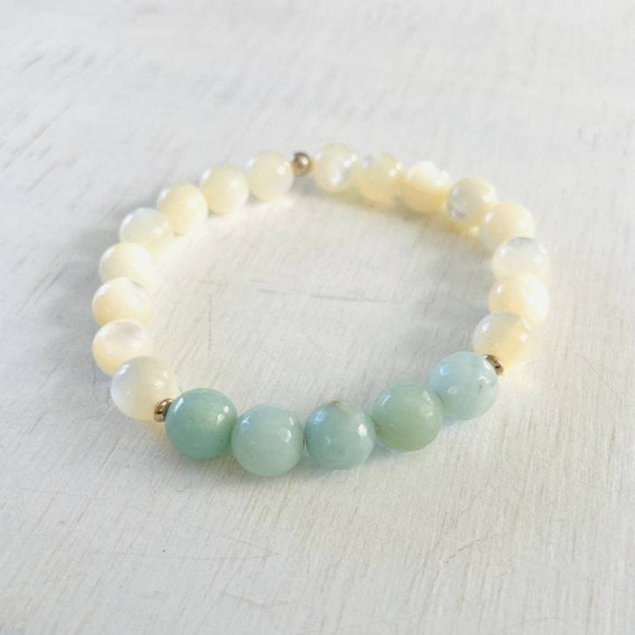 Amazonite & mother-of-pearl Balanced & Blissful Bracelet by ZEN by Karen Moore overhead view on white wood
