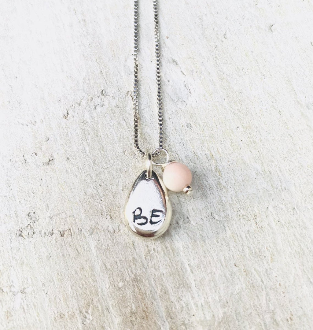 Just BE Free Charm Necklace by ZEN by Karen Moore Jewelry close up of charms on white wood