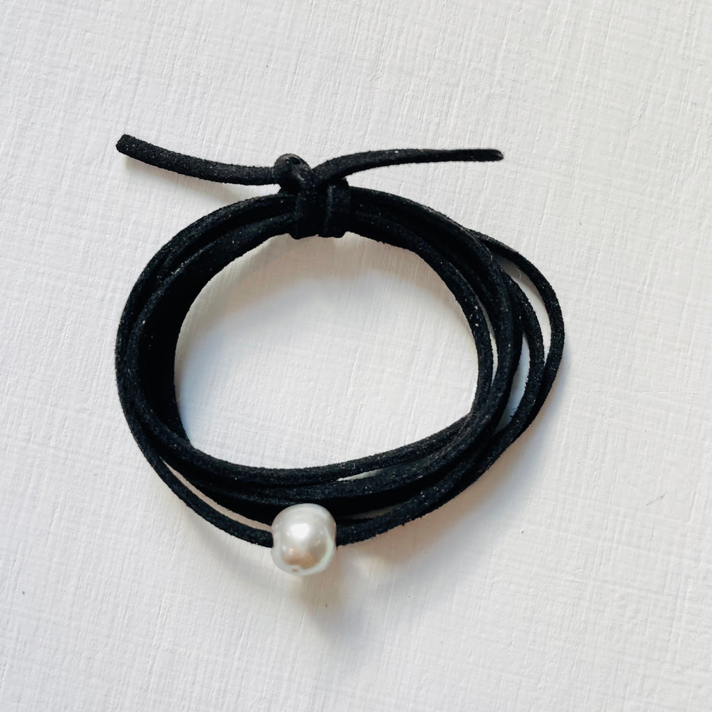 Pearl Of Wisdom Black Eco Zen Wrap Jewelry by ZEN by Karen Moore alt view on white wood 