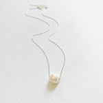 Floating Pearl Adjustable Necklace by ZEN by Karen Moore with silver chain on white background