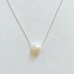 Floating Pearl Adjustable Necklace by ZEN by Karen Moore with silver chain on white background showing pearl gemstone