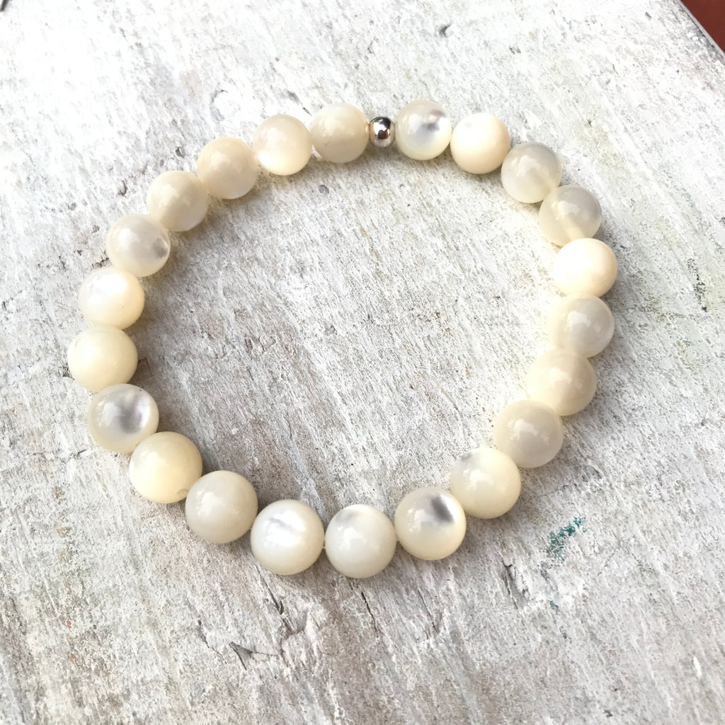 Be Nurtured Mother-of-Pearl Bracelet by ZEN by Karen Moore with gold accent bead on white wood