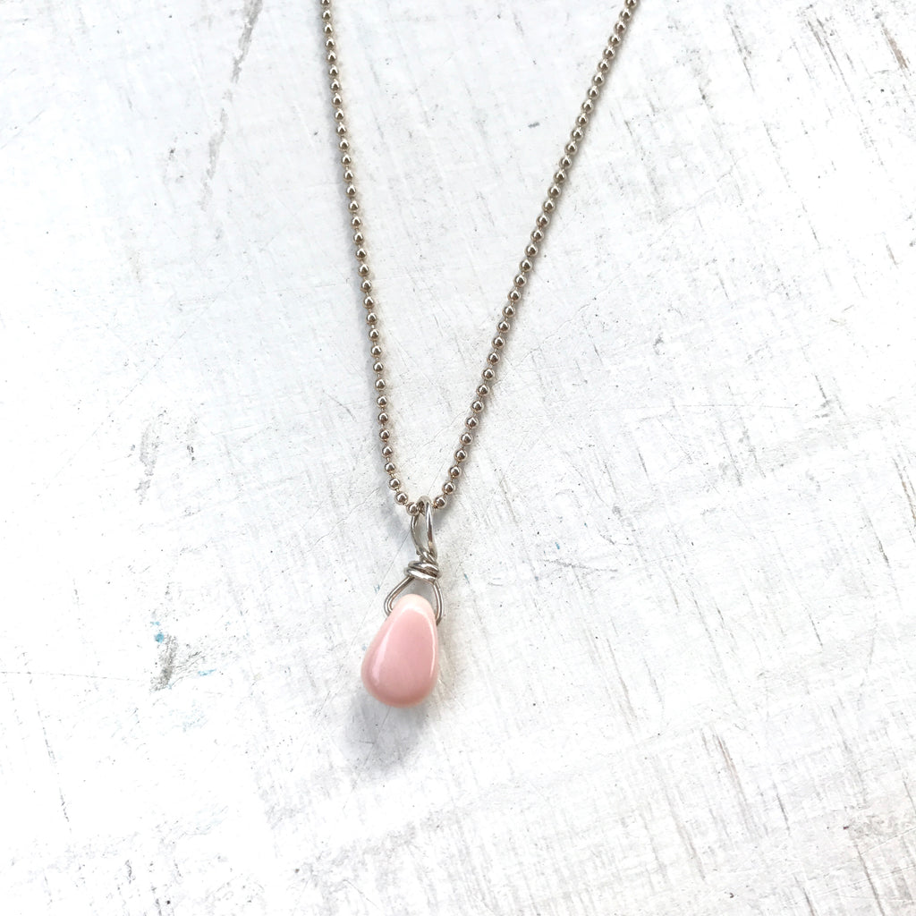 Delicate Inspiration conch shell necklace in sterling silver or 14k gold ball chain by ZEN by Karen Moore on white wood