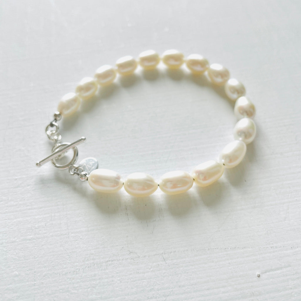 Brilliant White Pearl Bracelet by ZEN by Karen Moore jewelry with sterling silver clasp close up on white background