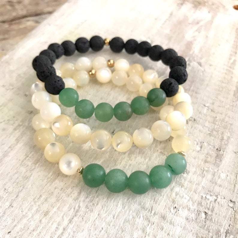 Aventurine and lava stone Be Well Aromatherapy Bracelet by ZEN by Karen Moore on white wood