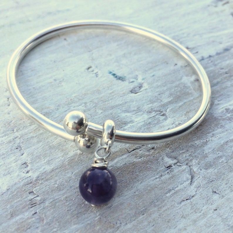 Amethyst Stability & Strength Bangle Bracelet by ZEN by Karen Moore on white wood