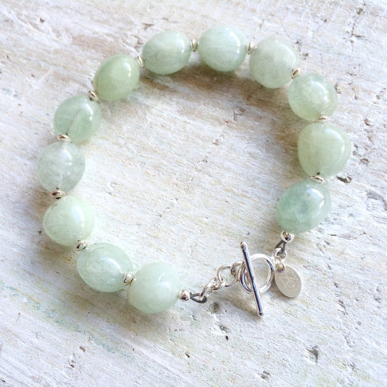 Courage To Be You Aquamarine Bracelet by ZEN by Karen Moore with silver accents overhead view on white background
