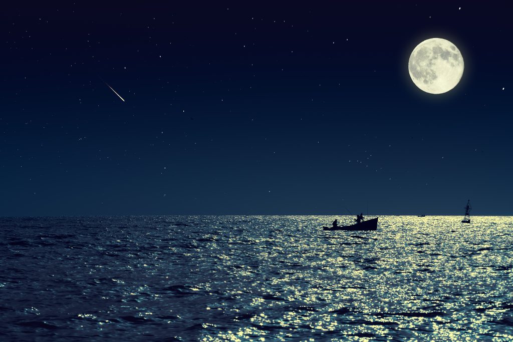 supermoon over a fishing boat