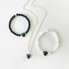 Hematite Heart gemstone charm necklace & Bracelets on a white background