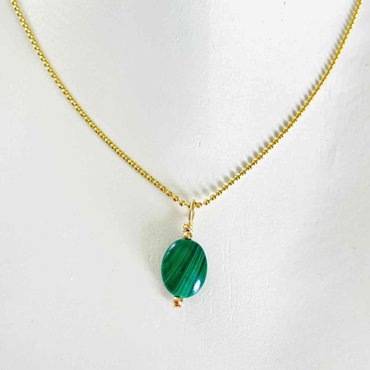 ZEN by Karen Moore green Malachite gemstone necklace on gold chain on white background