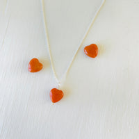 Aventurine gemstone charm necklace on sterling silver ball chain on a white background