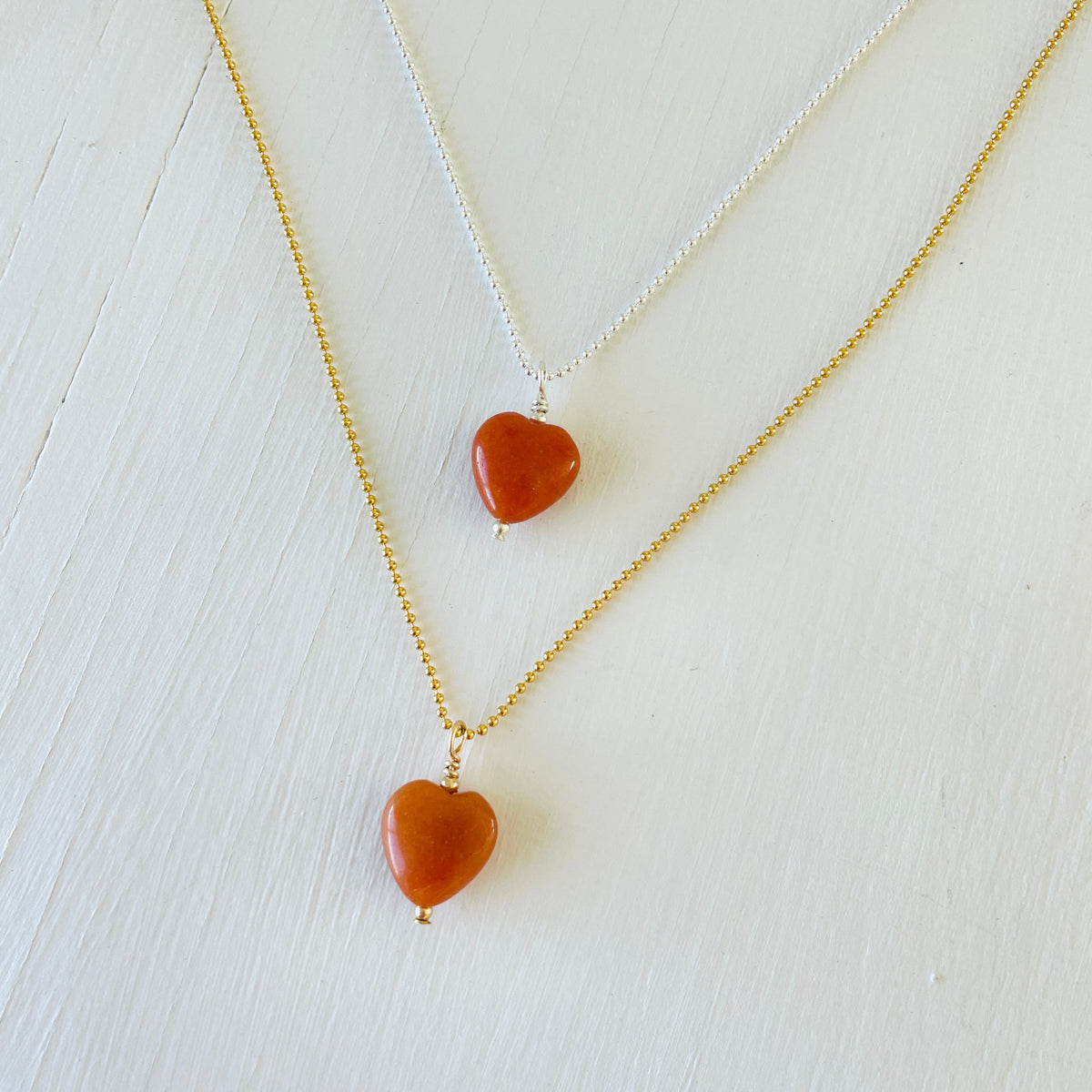 Orange Aventurine gemstone charm necklace on ball chain on a white background