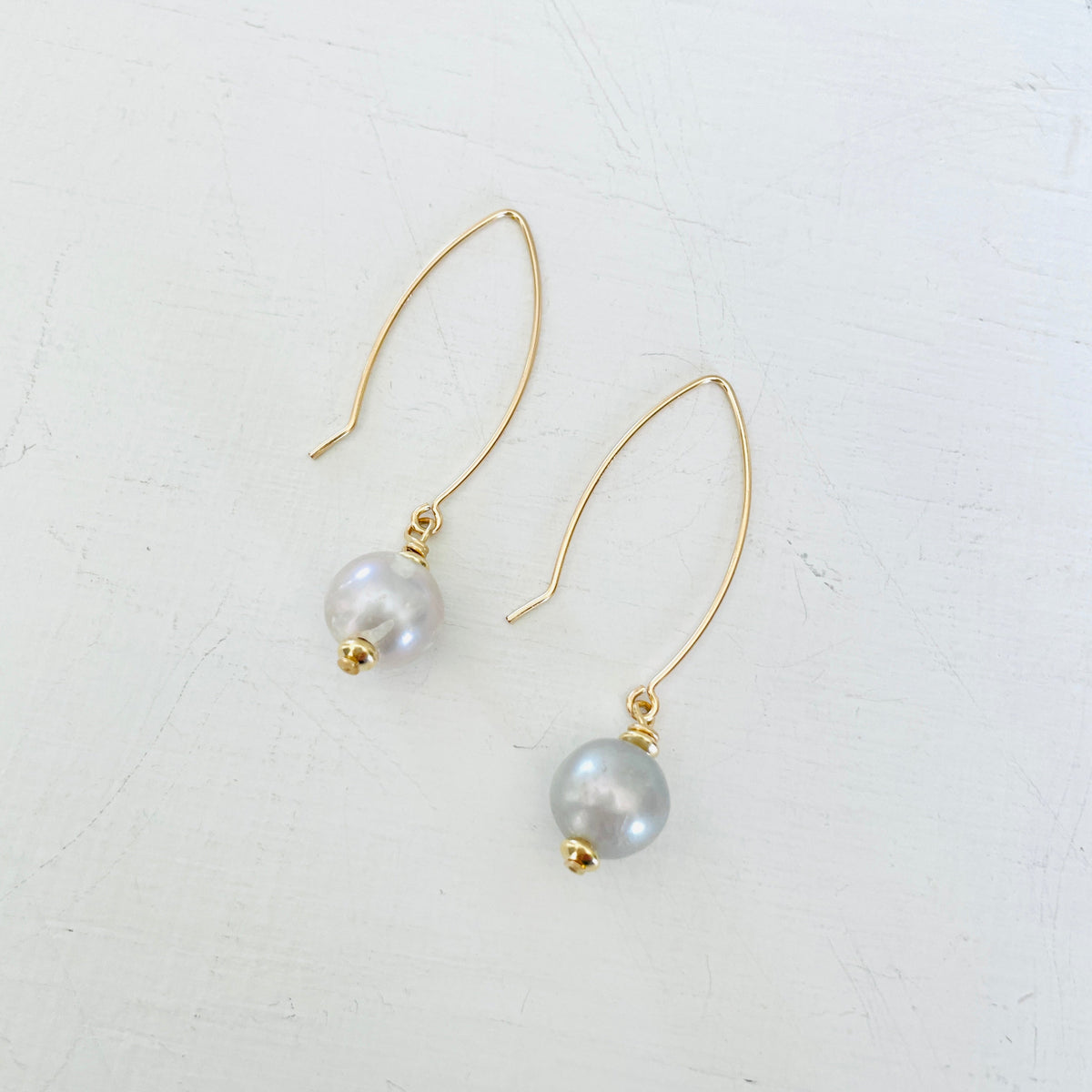 ZEN by Karen Moore Long Loop Gold Earrings with Grey Pearls on White Background