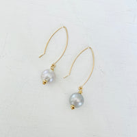 ZEN by Karen Moore Long Loop Gold Earrings with Grey Pearls on White Background