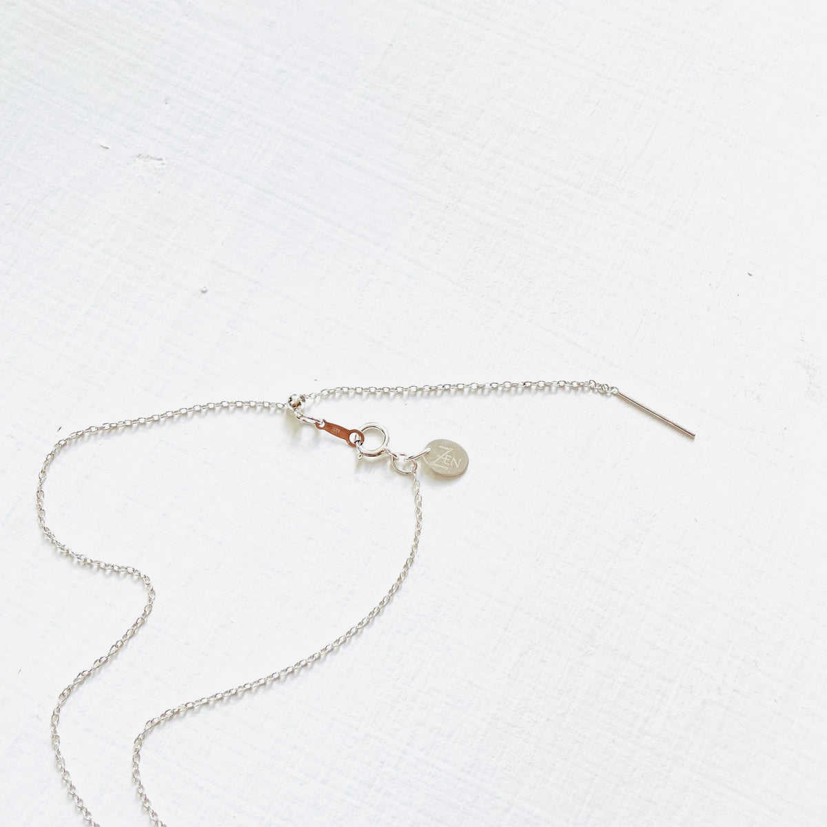Floating Adjustable Necklace by ZEN by Karen Moore showing silver adjustable chain on white background