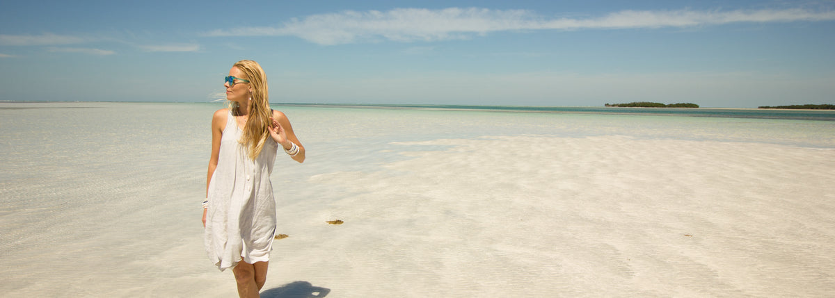 woman walking on the beach in ZEN by Karen Moore jewelry