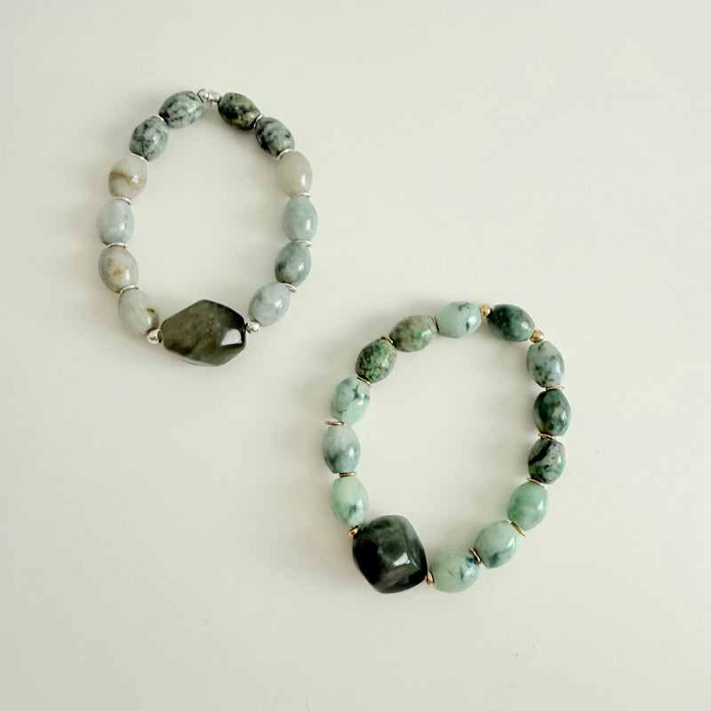 Two beaded bracelets with green and gray stones on a light background