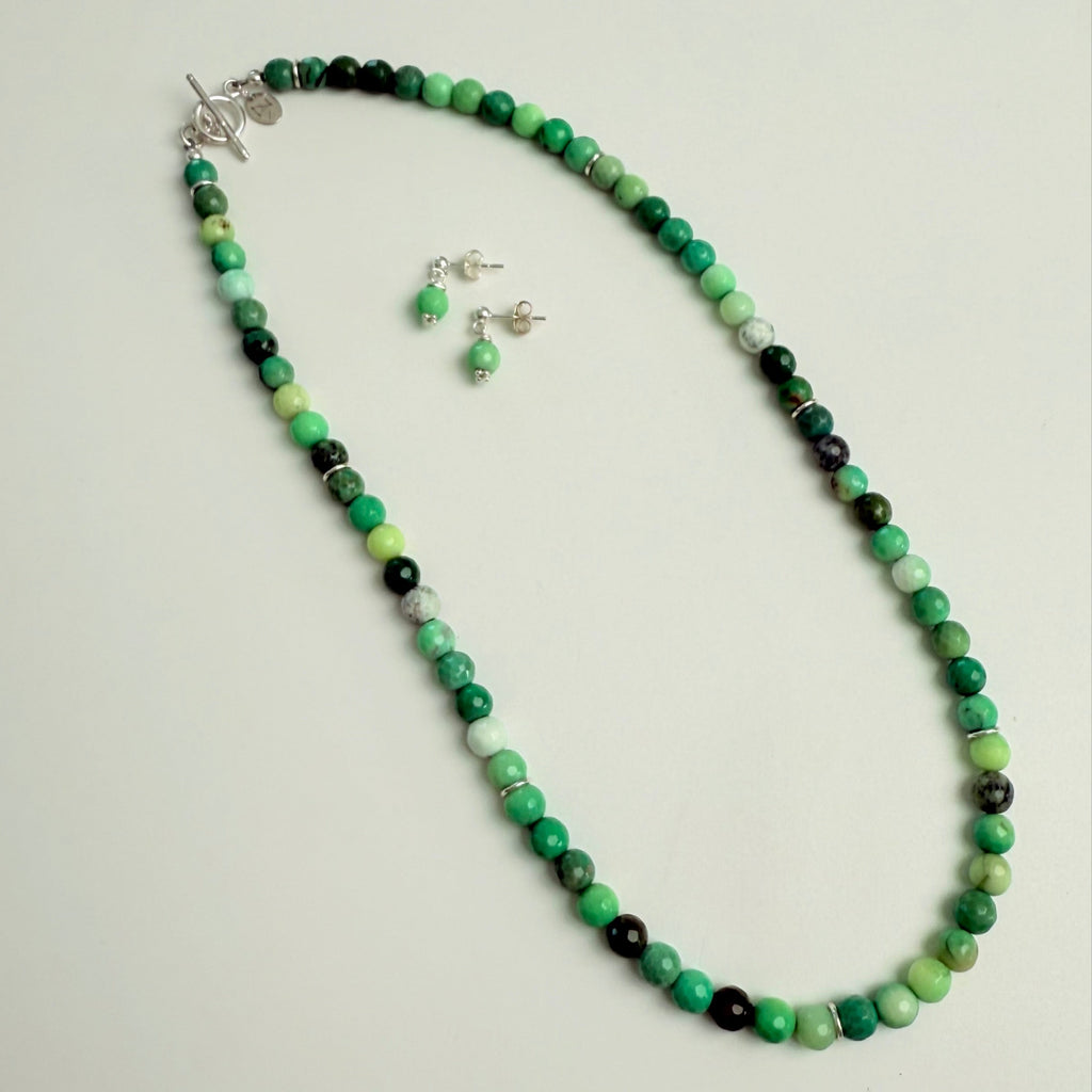 Earrings & Necklace with green and black beads on a white background