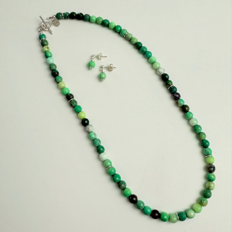 Earrings & Necklace with green and black beads on a white background