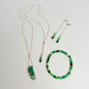 Two green beaded necklaces on a white background