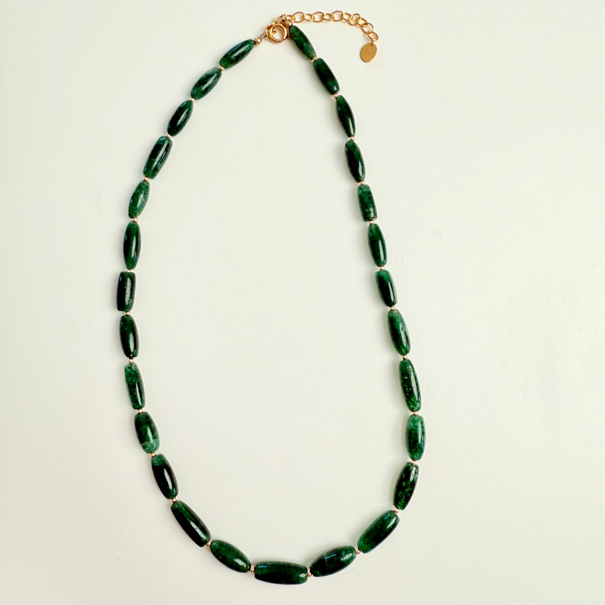 green jade gemstone necklace on white background with gold accents
ZEN-by-Karen-Moore-Jewelry_Indian-Jade-Necklace