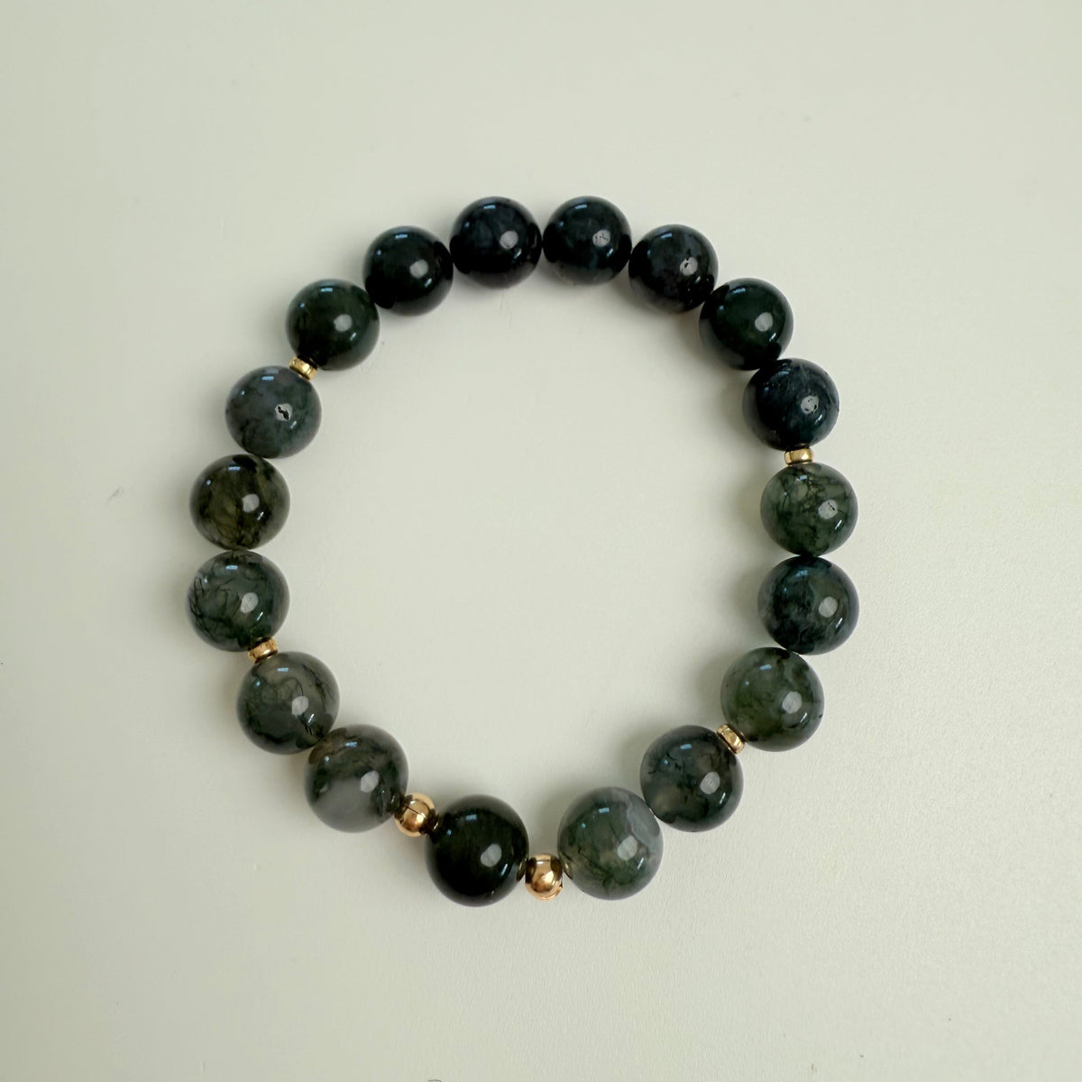 Green beaded bracelet on a white background