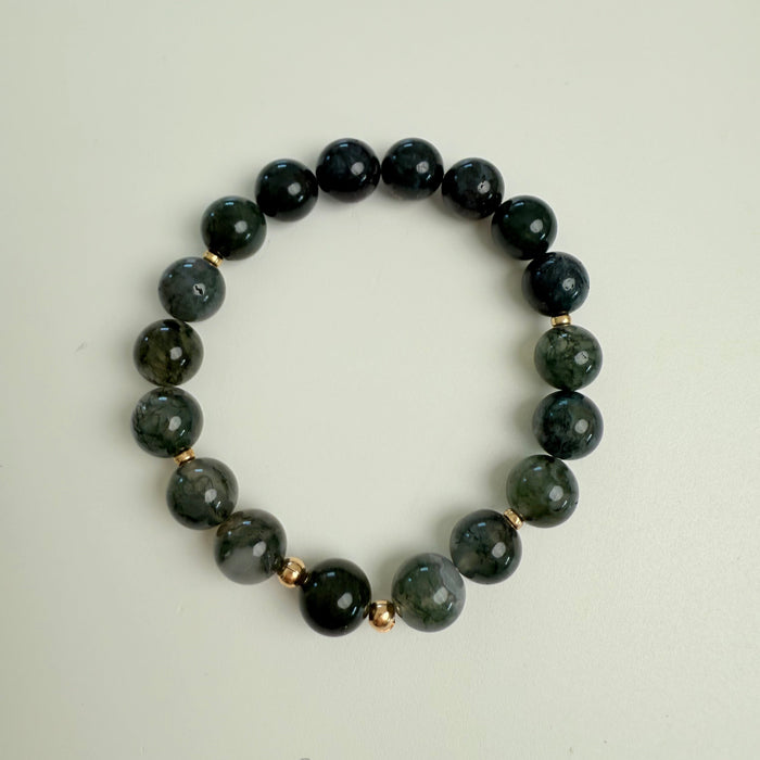 Green beaded bracelet on a white background