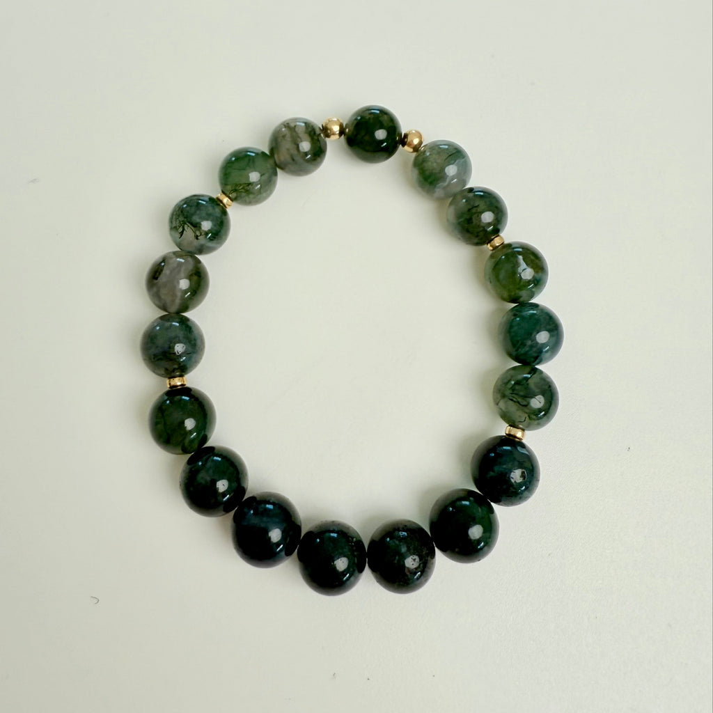 Green beaded bracelet on a white background