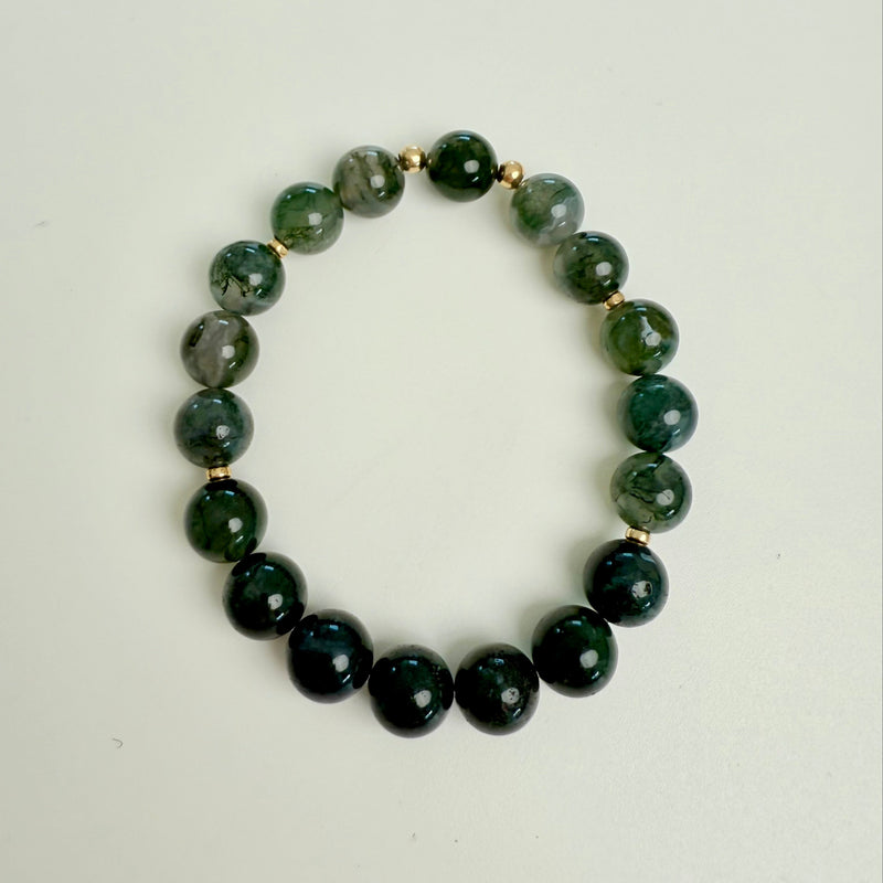 Green beaded bracelet on a white background