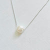 Floating Pearl Adjustable Necklace by ZEN by Karen Moore with silver chain on white background showing close up of pearl gemstone