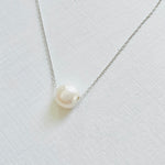 Floating Pearl Adjustable Necklace by ZEN by Karen Moore with silver chain on white background showing close up of pearl gemstone