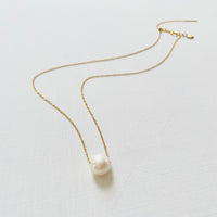Floating Pearl Adjustable Necklace by ZEN by Karen Moore with gold chain on white background