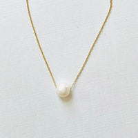 Floating Pearl Adjustable Necklace by ZEN by Karen Moore with gold chain on white background showing pearl gemstone