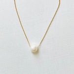 Floating Pearl Adjustable Necklace by ZEN by Karen Moore with gold chain on white background showing pearl gemstone