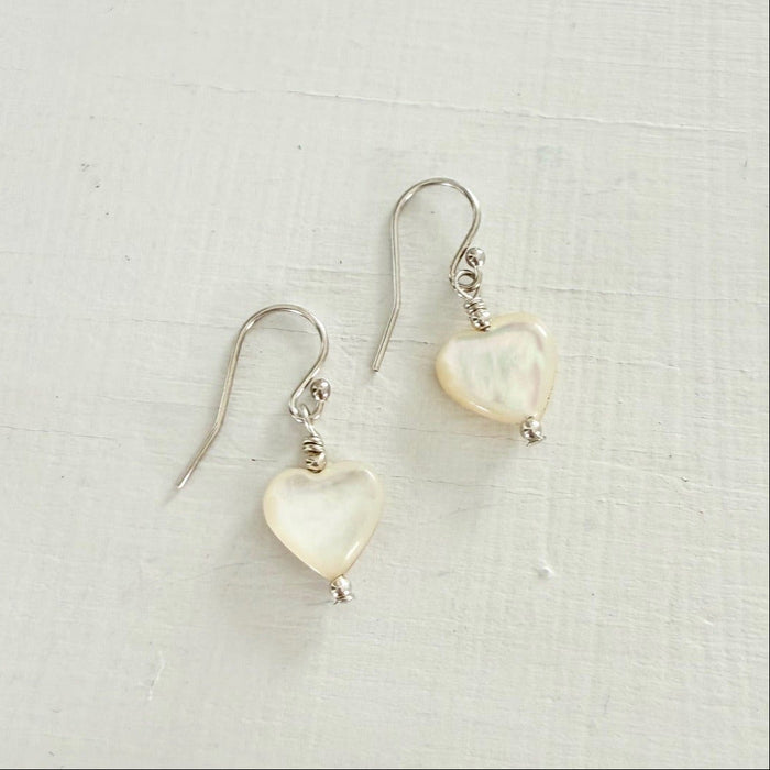 Heart-shaped earrings on a light gray background