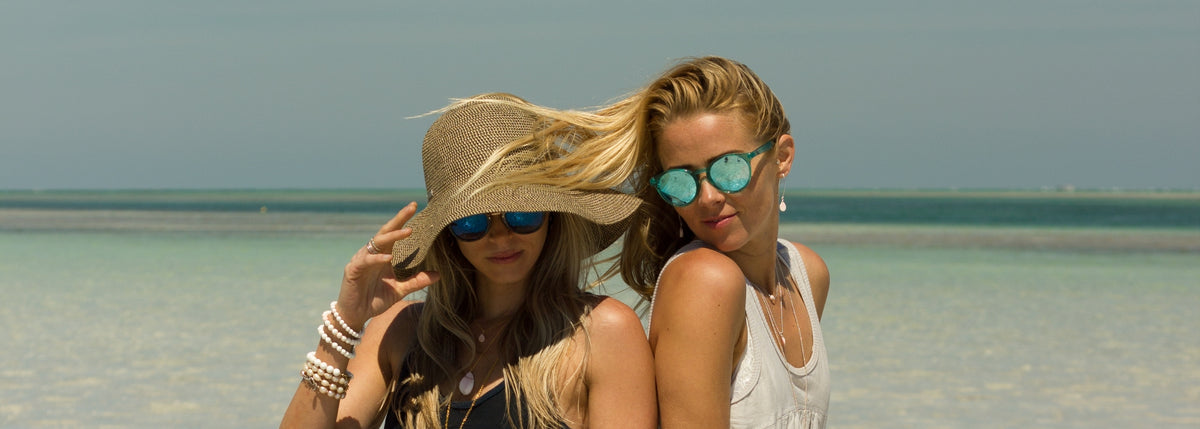 two women on the beach wearing ZEN by Karen Moore jewelry