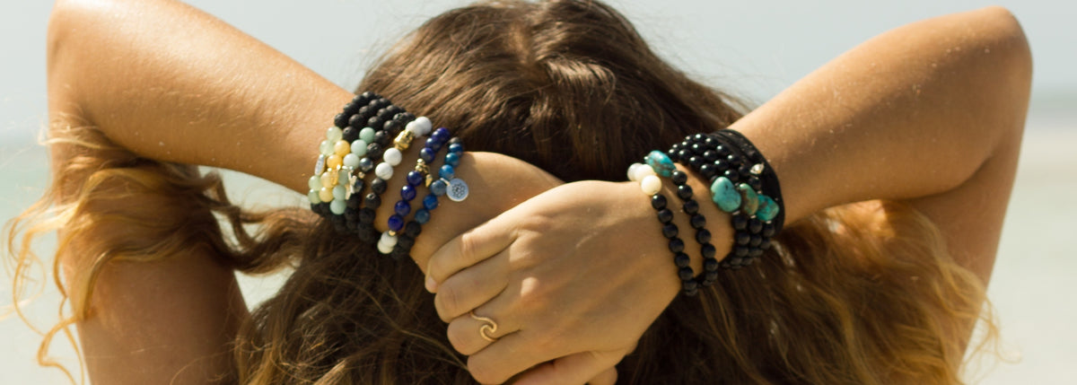 woman with her hands on her head wearing ZEN by Karen Moore handmade bracelets