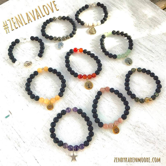 Overhead laydown of multiple Lava Love Aromatherapy Bracelets by ZEN by Karen Moore on white wood