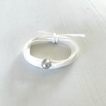 Pearl of Wisdom Pure White Eco Zen Wrap Jewelry by ZEN by Karen Moore on white wood