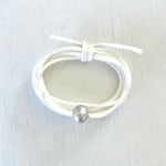 Pearl of Wisdom Pure White Eco Zen Wrap Jewelry by ZEN by Karen Moore on white wood