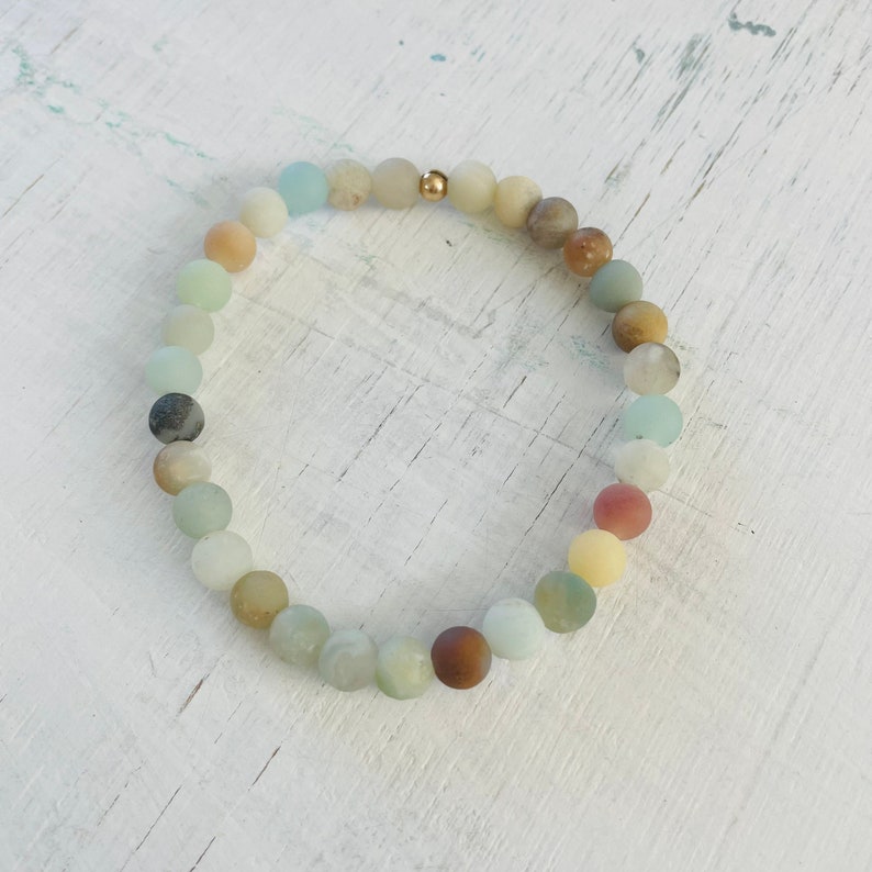 Be Kind Mini Gem Amazonite Bracelet by ZEN by Karen Moore overhead view on white wood
