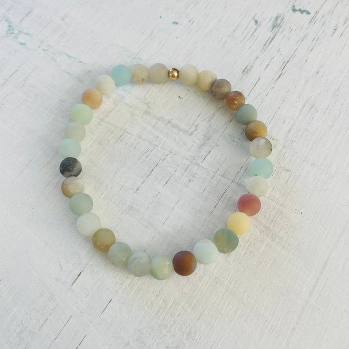 Be Kind Mini Gem Amazonite Bracelet by ZEN by Karen Moore overhead view on white wood