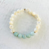 Amazonite & mother-of-pearl Balanced & Blissful Bracelet by ZEN by Karen Moore overhead view on white wood