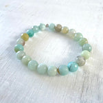 Feel Balance Within Amazonite Bracelet by ZEN by Karen Moore angled view on white wood