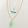 Trio of blue and turquoise 14K gold pendant necklaces by ZEN by Karen Moore on white background