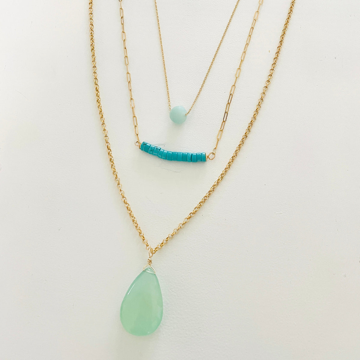 complimentary Layered Blue Gemstone Necklace trio by ZEN by Karen Moore on white background close up